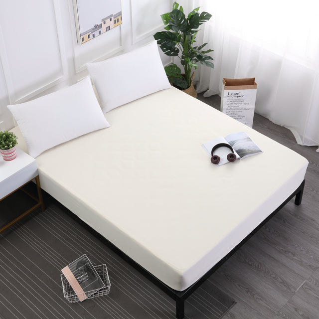 Solid color waterproof bed mattress protector with elastic band.
